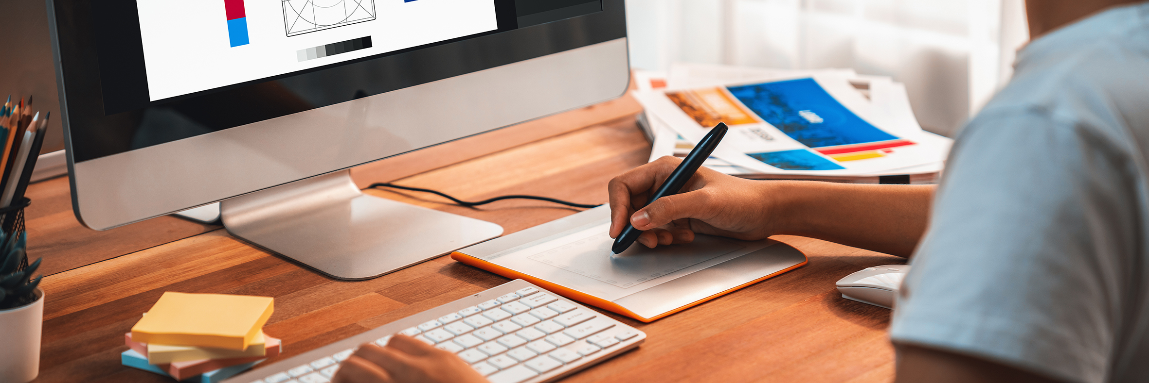 Graphic designer works on computer laptop with digital pen. Scrutinize