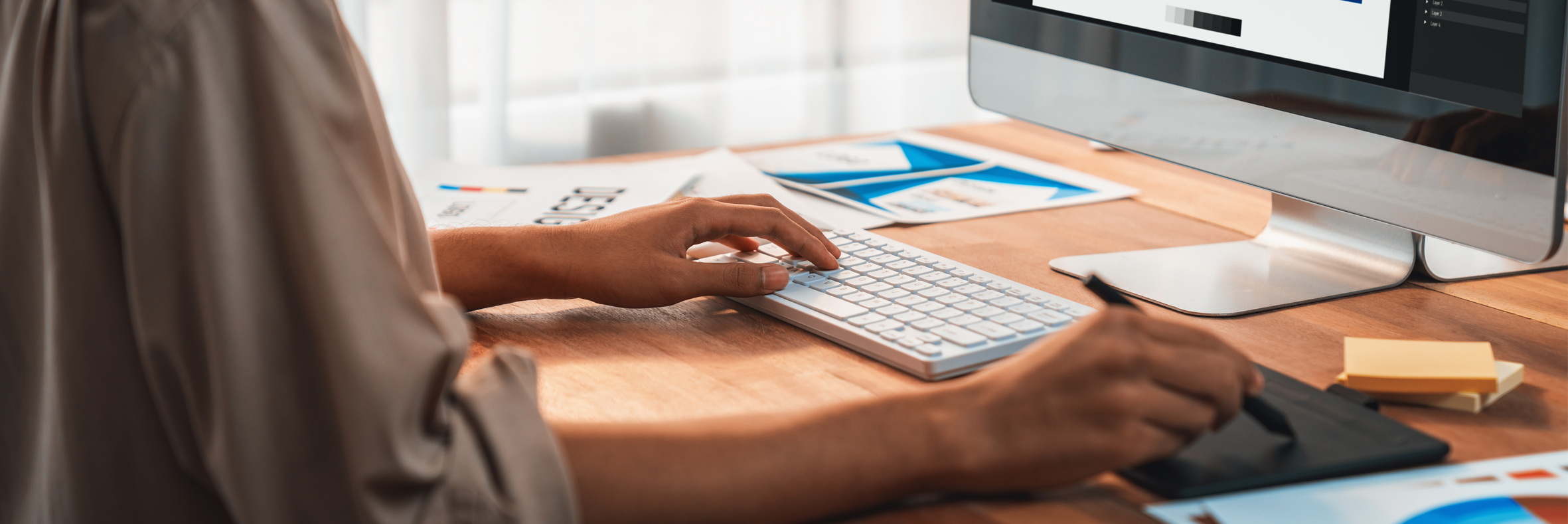 Graphic designer works on computer laptop with digital pen. Scrutinize